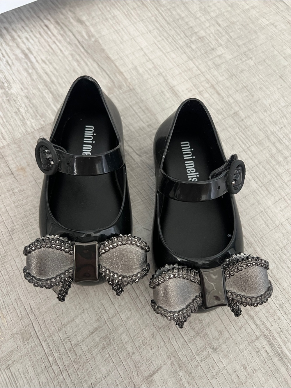 Mini Melissa Black Mary Jane Flats with Metallic Bow